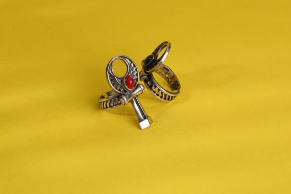 silver ankh cross ring plated gold decorated with red gems.