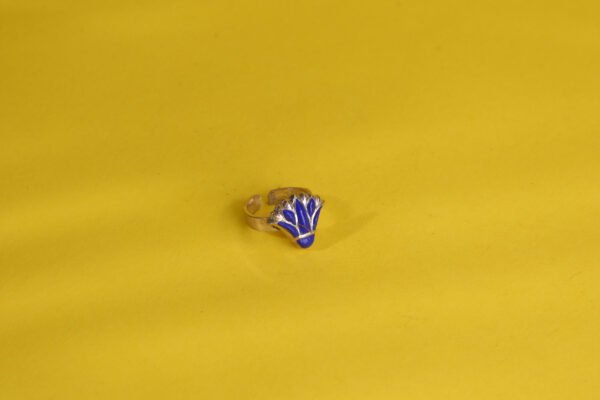 lotus flower sterling silver ring decorated with blue gems.